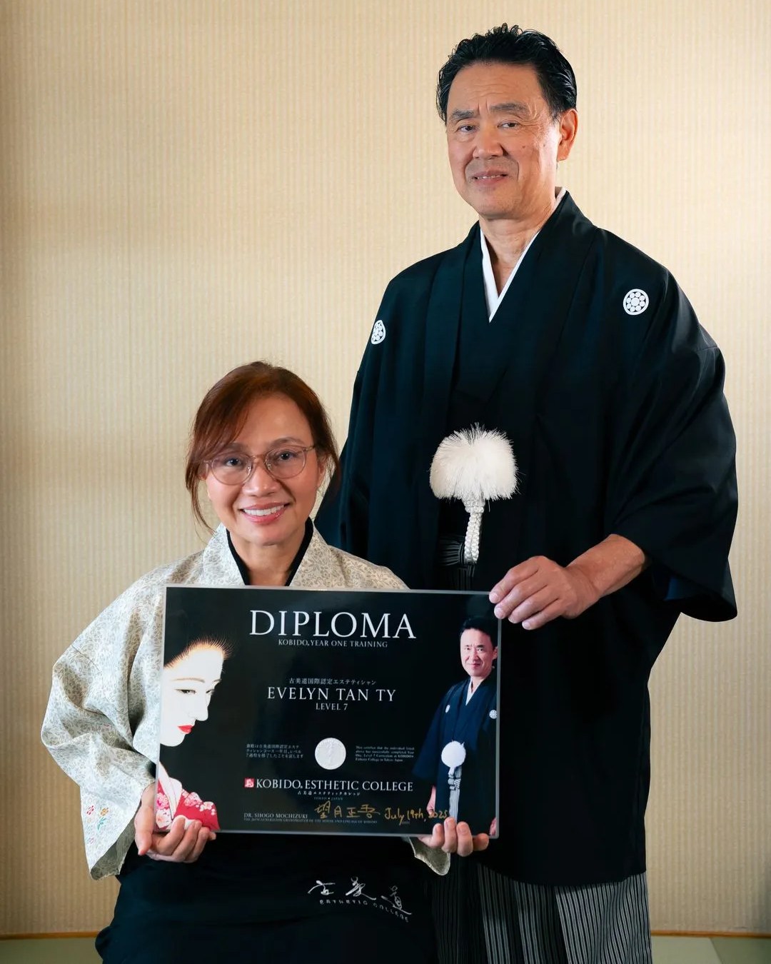 Kobido practitioner Evelyn Tan Ty with Grandmaster Dr. Shogo Mochizuki, holding her Kobido diploma
